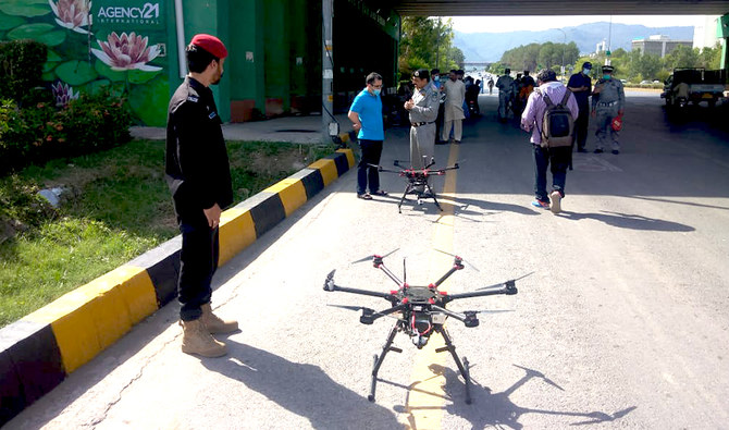 In this photo, Islamabad traffic police stand near drones ready to monitor traffic in Islamabad, Pakistan on June 14, 2021. (Photo courtesy: Islamabad Traffic Police)