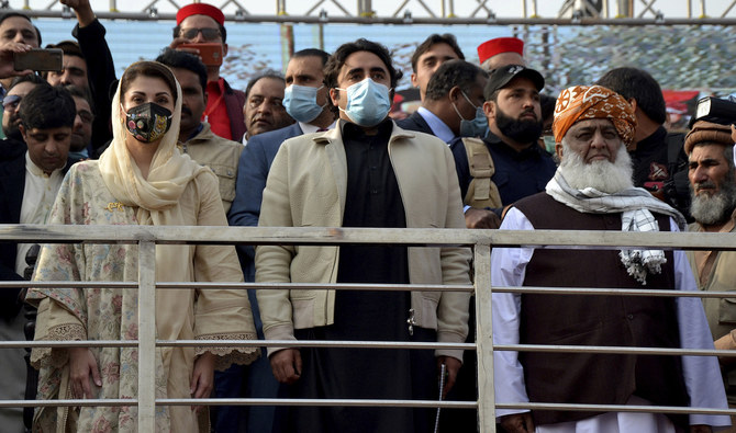 Maulana Fazal-ur-Rehman, right in front row, Bilawal Bhutto Zardari, center, Maryam Nawaz Sharif, left, leaders of the Pakistan Democratic Movement, an alliance of opposition parties, attend an anti-government rally in Peshawar on Nov. 22, 2020. (AFP/ File)