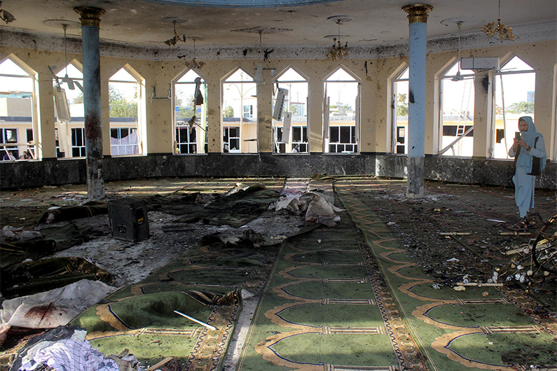 An Afghan man films inside a mosque after a blast, in Kunduz, Afghanistan October 8, 2021. (REUTERS)