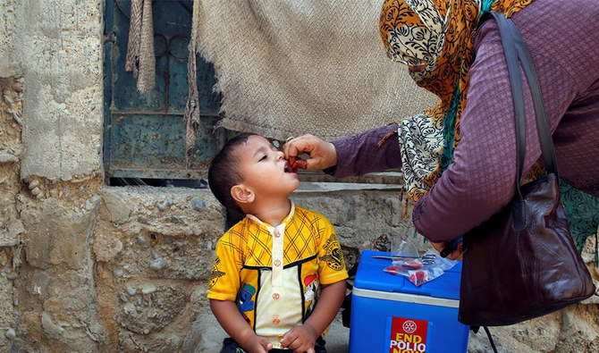 A boy receives polio vaccine drops, during an anti-polio campaign, in a low-income neighbourhood in Karachi, Pakistan April 9, 2018. (Reuters)