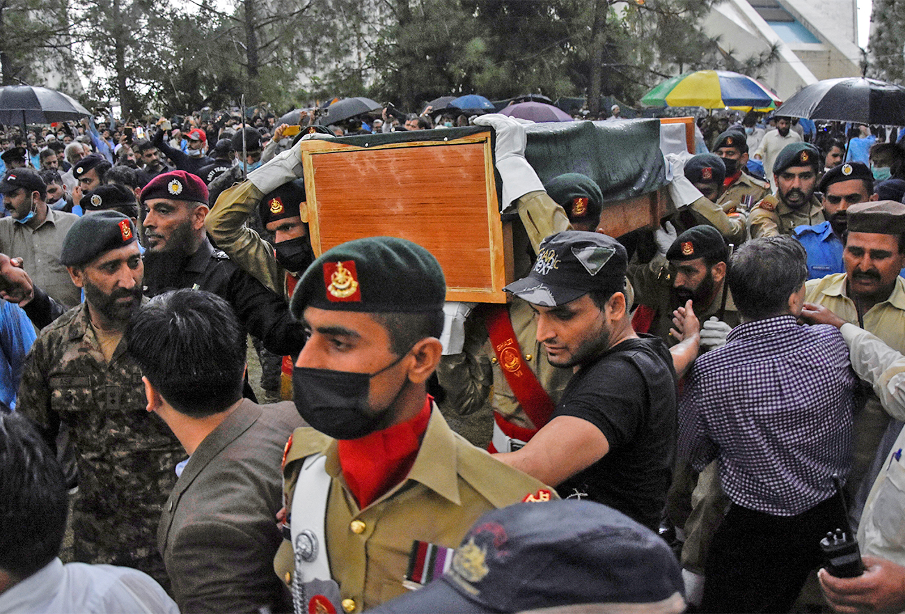 Army soldiers carry the national flag-draped coffin of Pakistan's nuclear scientist Abdul Qadeer Khan, during his funeral in Islamabad, Pakistan, on October 10, 2021. (REUTERS)