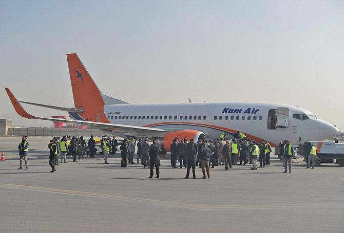 Kam Air employees gather by an airplane at Kabul International Airport in Afghanistan on January 24, 2018. (AFP/File)