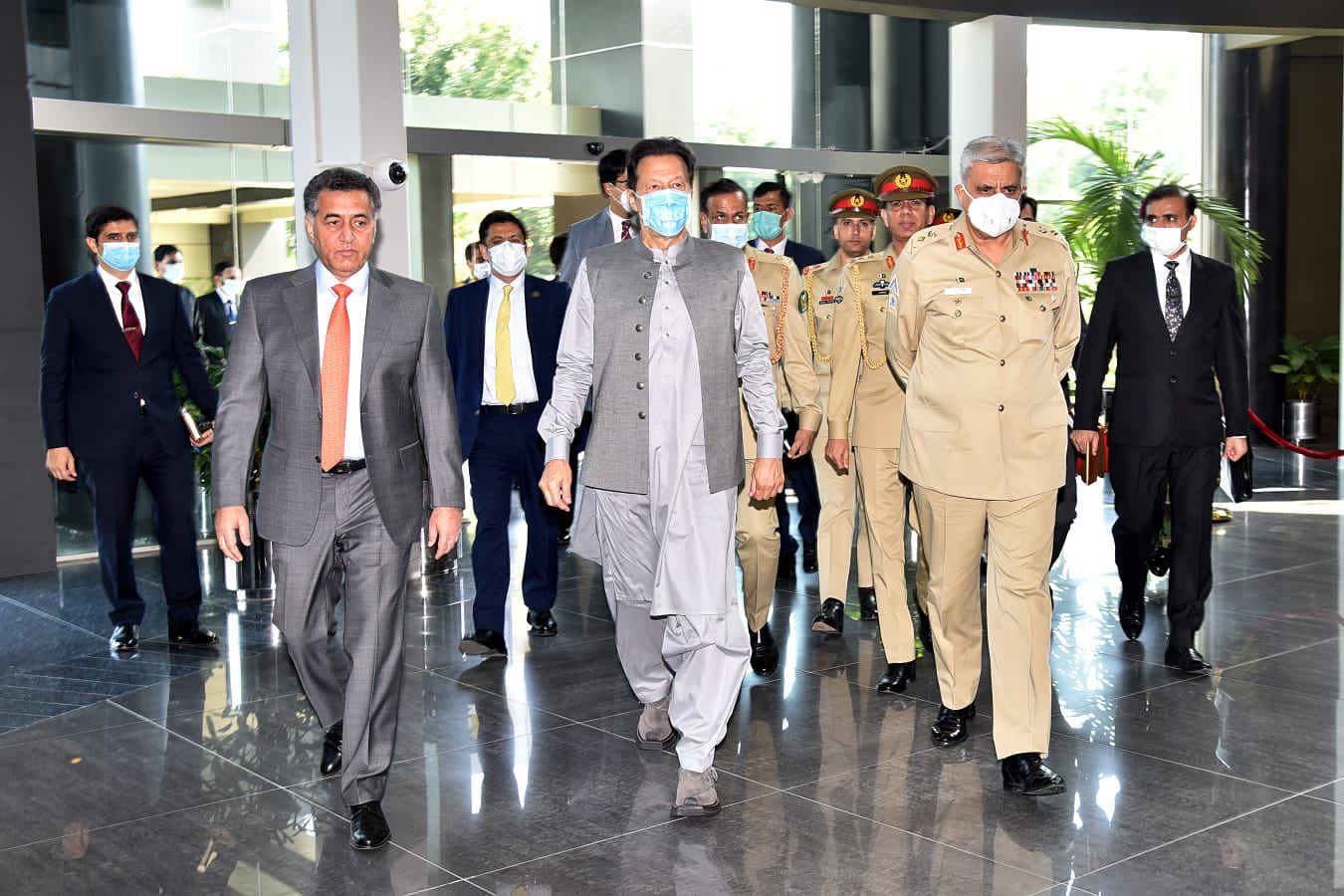 ISI chief Lt Gen Faiz Hameed (left) Prime Minister Imran Khan (center) Chief of the Army Staff General Qamar Javed Bajwa (right) enters ISI headquarters on May 24, 2021. (Pak PM Office)