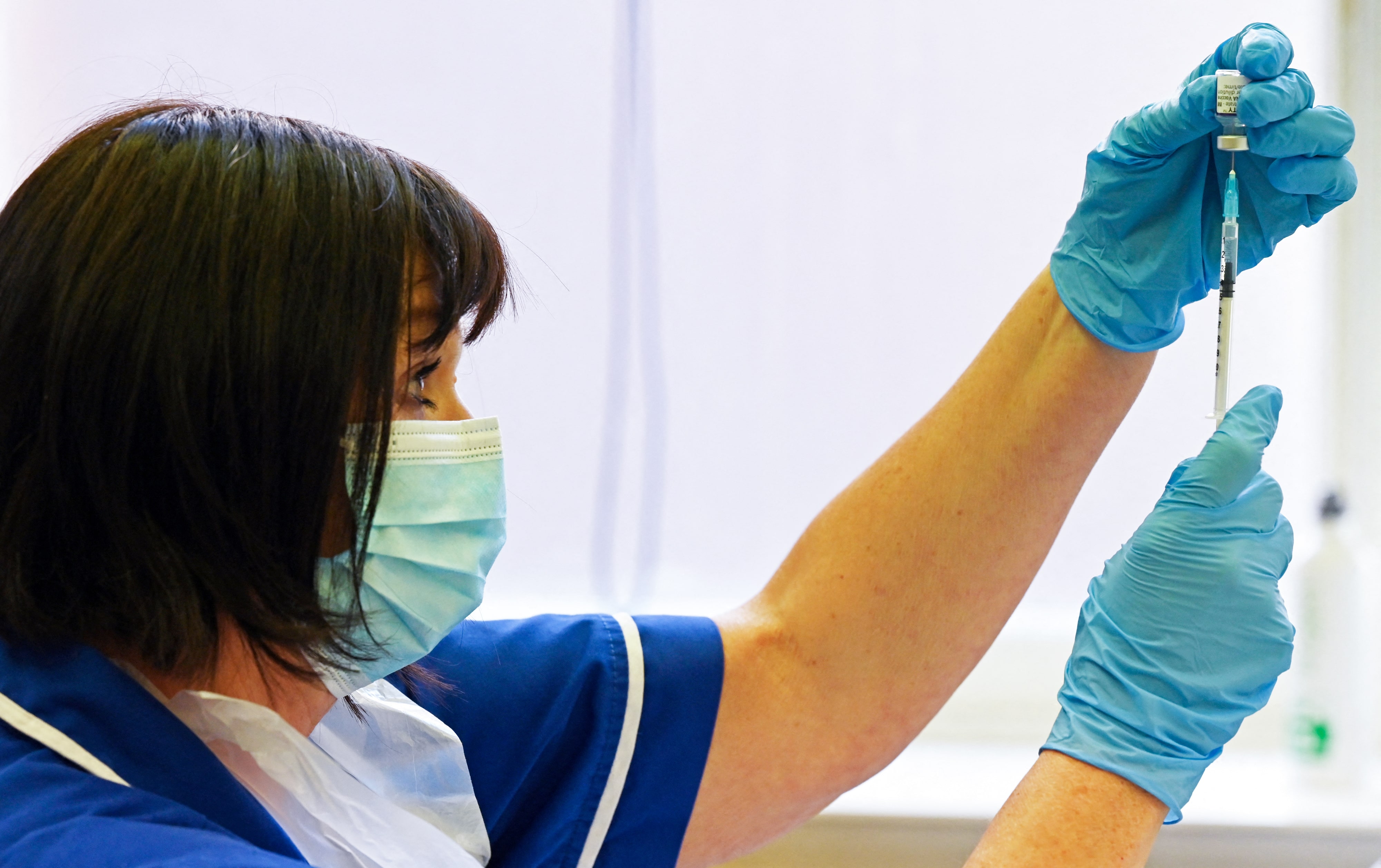 In this file photo taken on September 20, 2021 a nurse prepares a dose the Pfizer-BioNtech vaccine at a vaccination centre in Derby, central England. (AFP)
