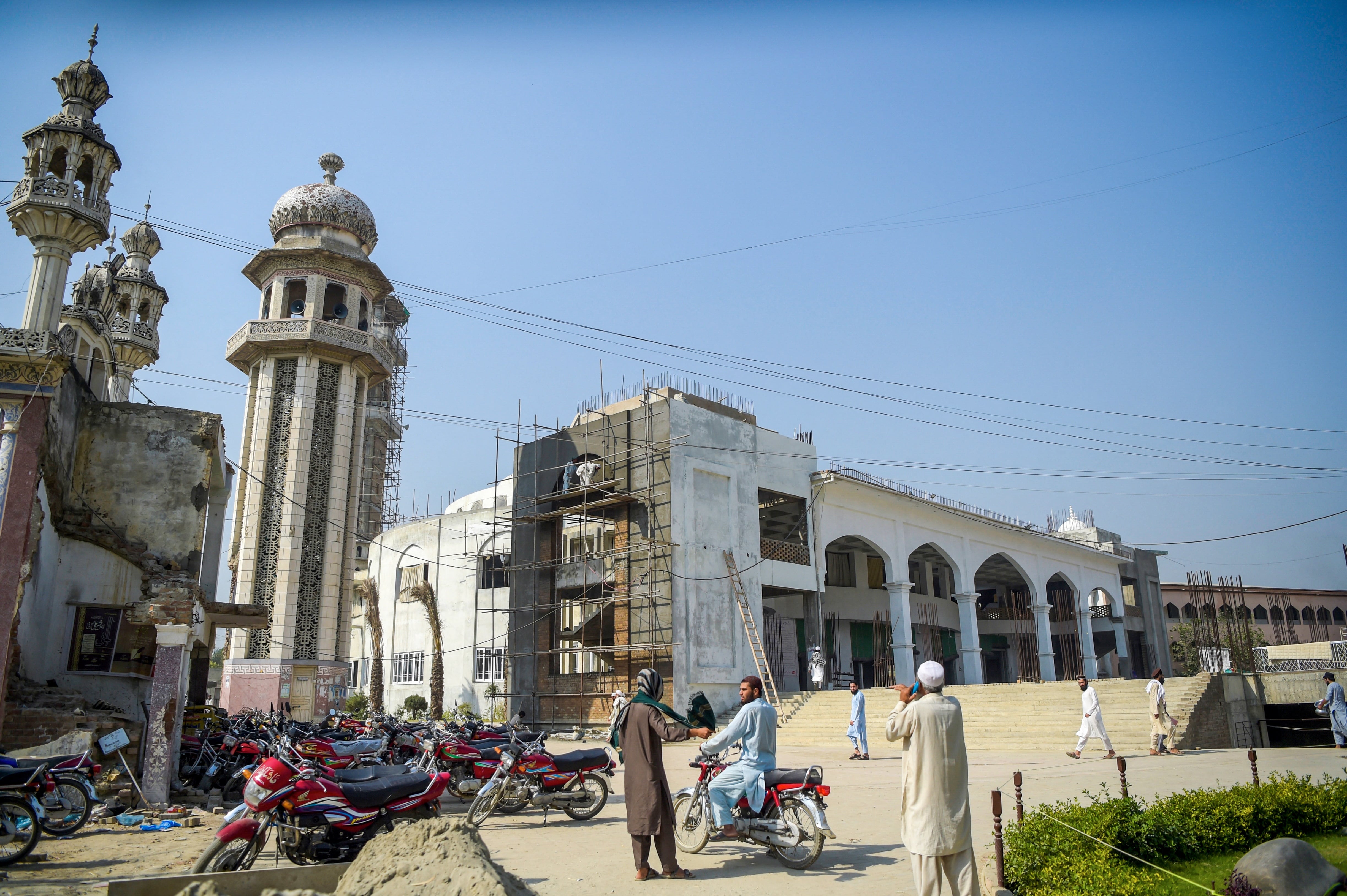 In this picture taken on October 19, 2020 Islamic seminary students stand outside the Darul Uloom Haqqania seminary in Akora Khattak. (AFP)