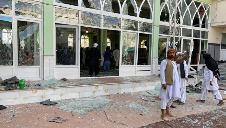 Afghan men are seen outside a Shiite mosque in Kandahar on October 15, 2021. (Photo courtesy: Getty Images)
