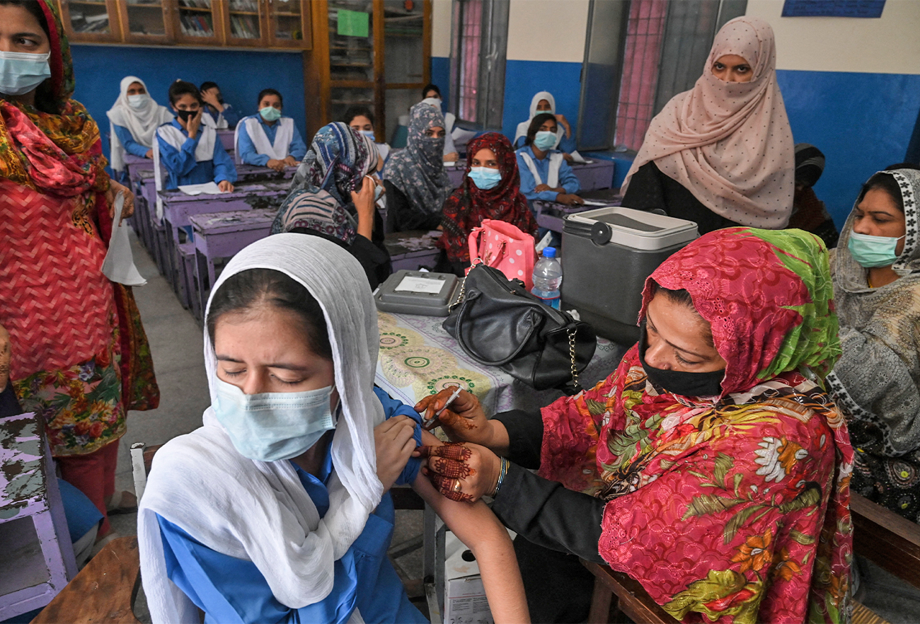 A health worker inoculates a student with a dose of Pfizer vaccine against the coronavirus at a school in Lahore, Pakistan, on October 5, 2021. (AFP/File)