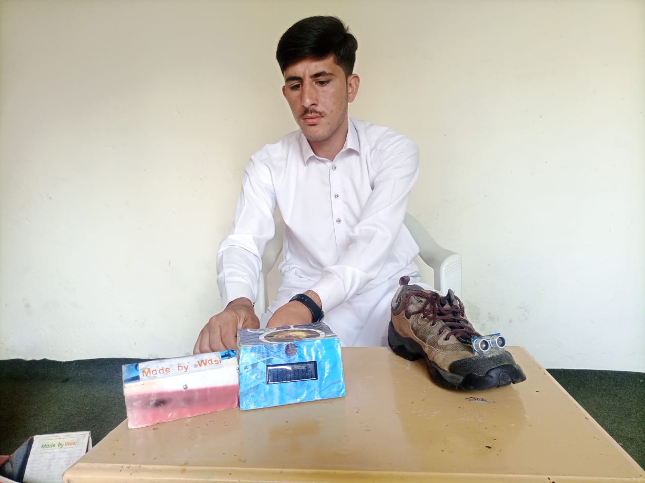 Wasiullah, the inventor of "smart shoes" for the blind poses at his home in Swat, northwestern Pakistan on October 13, 2021. (Photo courtesy: Wasiullah)