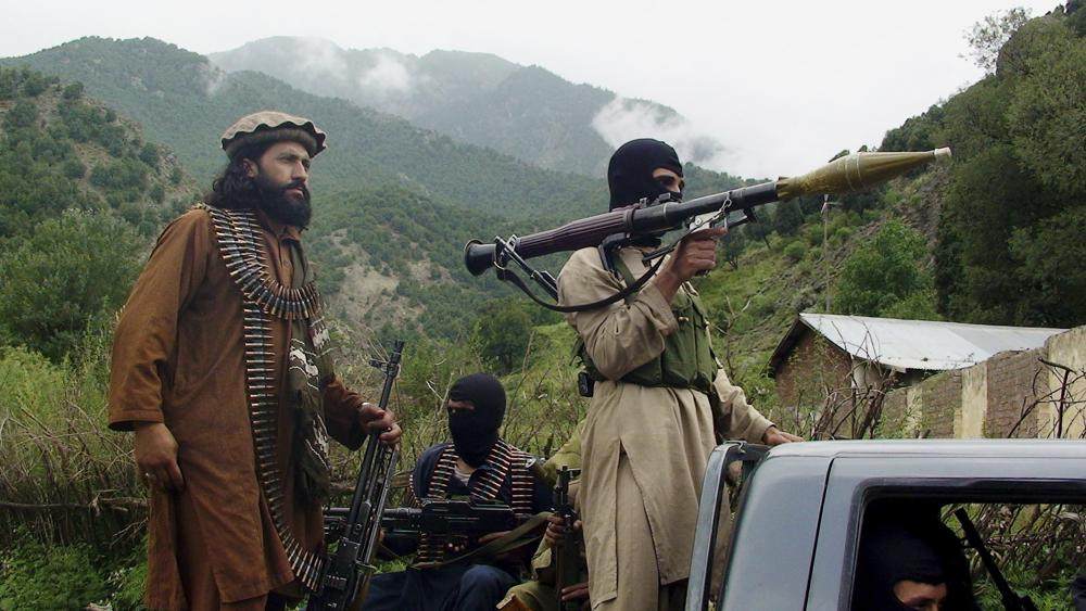 In this Aug. 5, 2012 file photo, Pakistani Taliban patrol in then their stronghold of Shawal in Pakistani tribal region of South Waziristan. The Taliban win in Afghanistan is giving a boost to militants in neighboring Pakistan. (AP/ File Photo)