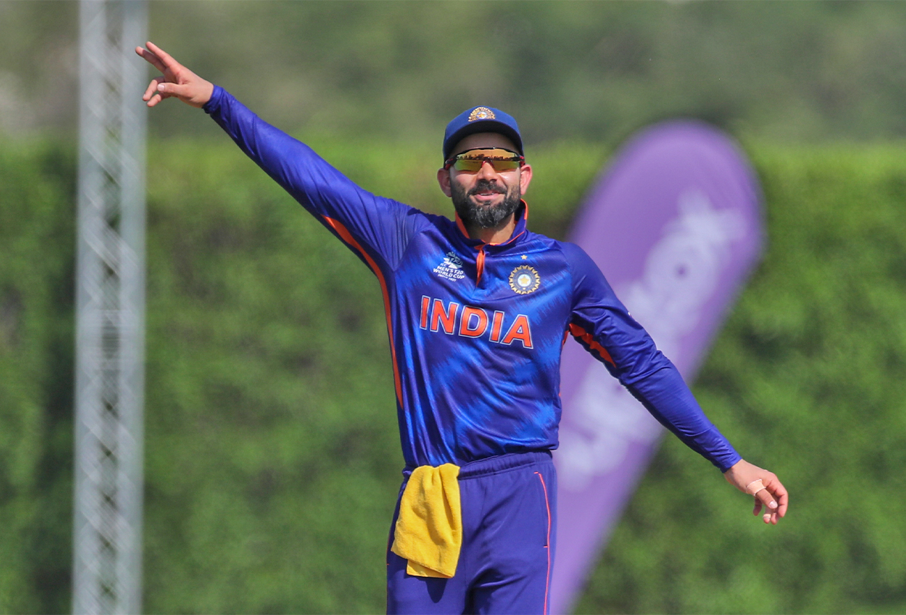 India's captain Virat Kohli gestures to his teammates during the Cricket Twenty20 World Cup warm-up match between India and Australia in Dubai, UAE, on October 20, 2021. (AP)