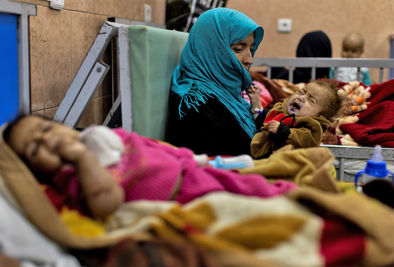 A woman holds her one-year-old baby at the malnutrition ward for infants of Indira Gandhi Children's hospital in Kabul, Afghanistan, on October 23, 2021. (REUTERS)