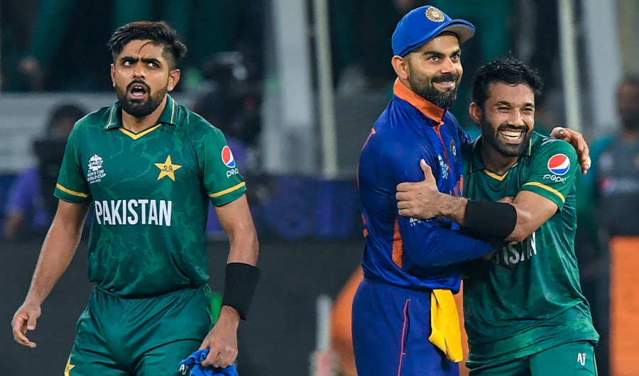 India's captain Virat Kohli (C) congratulates his Pakistan's counterpart Babar Azam (L) and Mohammad Rizwan at the Dubai International Cricket Stadium in Dubai on October 24, 2021. (AFP)