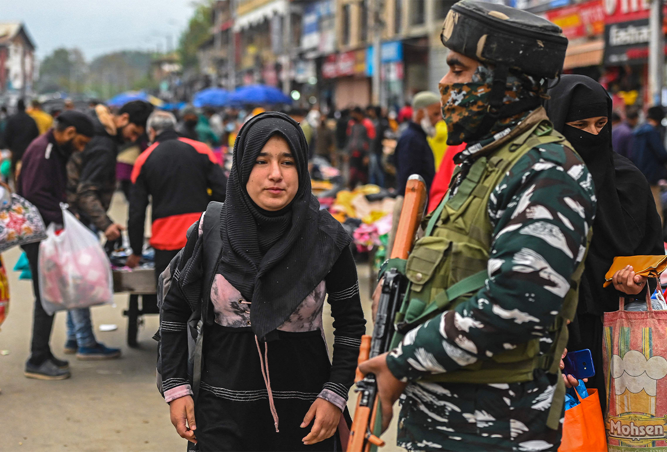 An Indian paramilitary trooper stands guard at a market in Srinagar on October 24, 2021. (AFP)