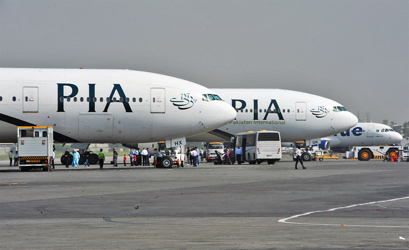 Pakistan International Airline (PIA) planes are positioned on the tarmac at the Benazir Bhutto International Airport in Islamabad, Pakistan, on October 10, 2012. (AFP/File)