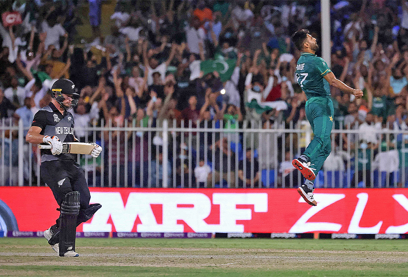Pakistan's Haris Rauf (R) celebrates the dismissal of New Zealand's Devon Conway during the ICC men’s Twenty20 World Cup cricket match between Pakistan and New Zealand at the Sharjah Cricket Stadium in Sharjah on October 26, 2021. (AFP)