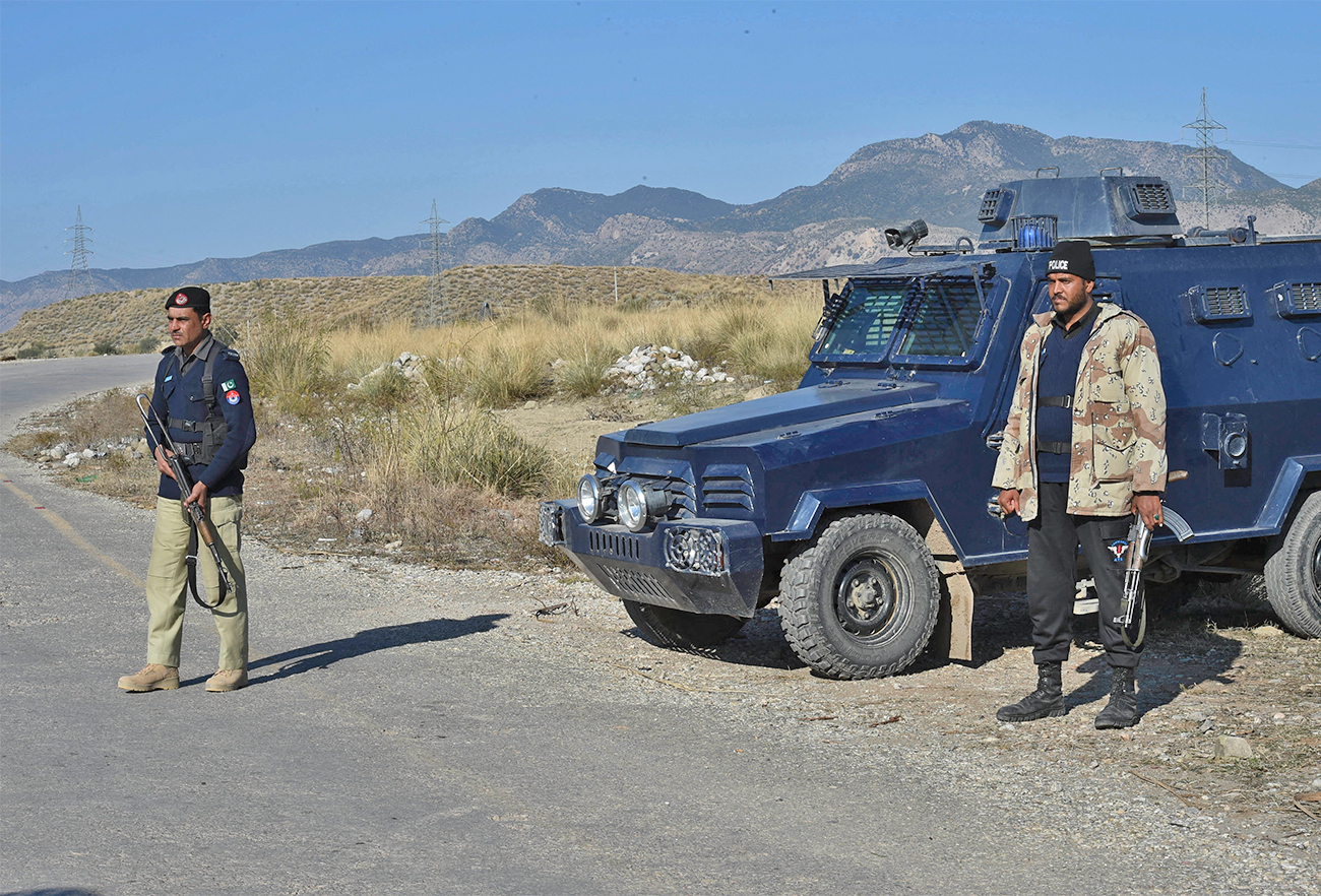 Policemen stand guard along a road near the burnt Hindu temple a day after a mob attack in a remote village in Karak district, some 160 kms southeast of Peshawar, Pakistan, on December 31, 2020. (AFP/File)
