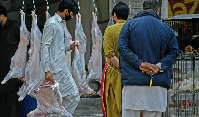 A butcher wearing a facemask carries goat meat at a market during a government-imposed nationwide lockdown as a preventive measure against the spread of the COVID-19 coronavirus, in Islamabad on April 9, 2020. (AFP/File)