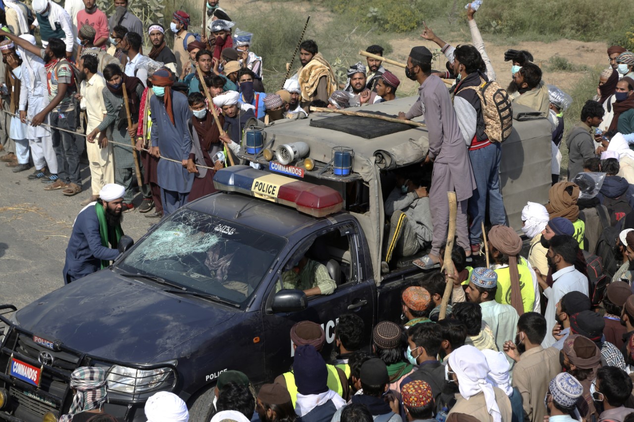 Supporters of Tehreek-e-Labiak Pakistan, a radical Islamist party, celebrate after capturing a police vehicle during their protest march toward Islamabad, on a highway in the town of Sadhuke, in eastern Pakistan, Wednesday, Oct. 27, 2021. (AP Photo)