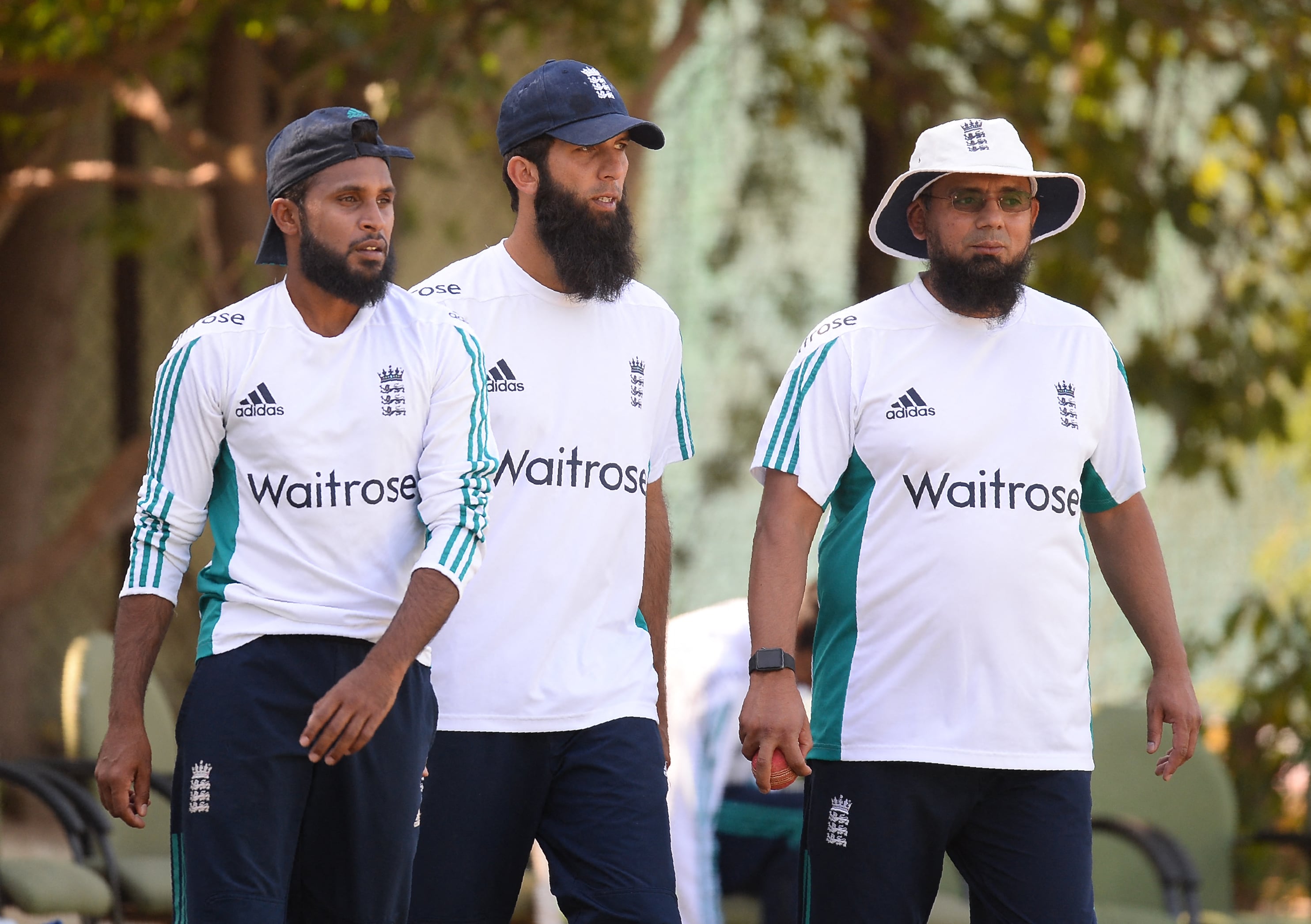 (L-R) England's cricketer Adil Rashid, Moeen Ali, and bowling coach Saqlain Mushtaq walk towards the nets during a training session at the Punjab Cricket Association Stadium in Mohali on November 25, 2016. (AFP/ File)