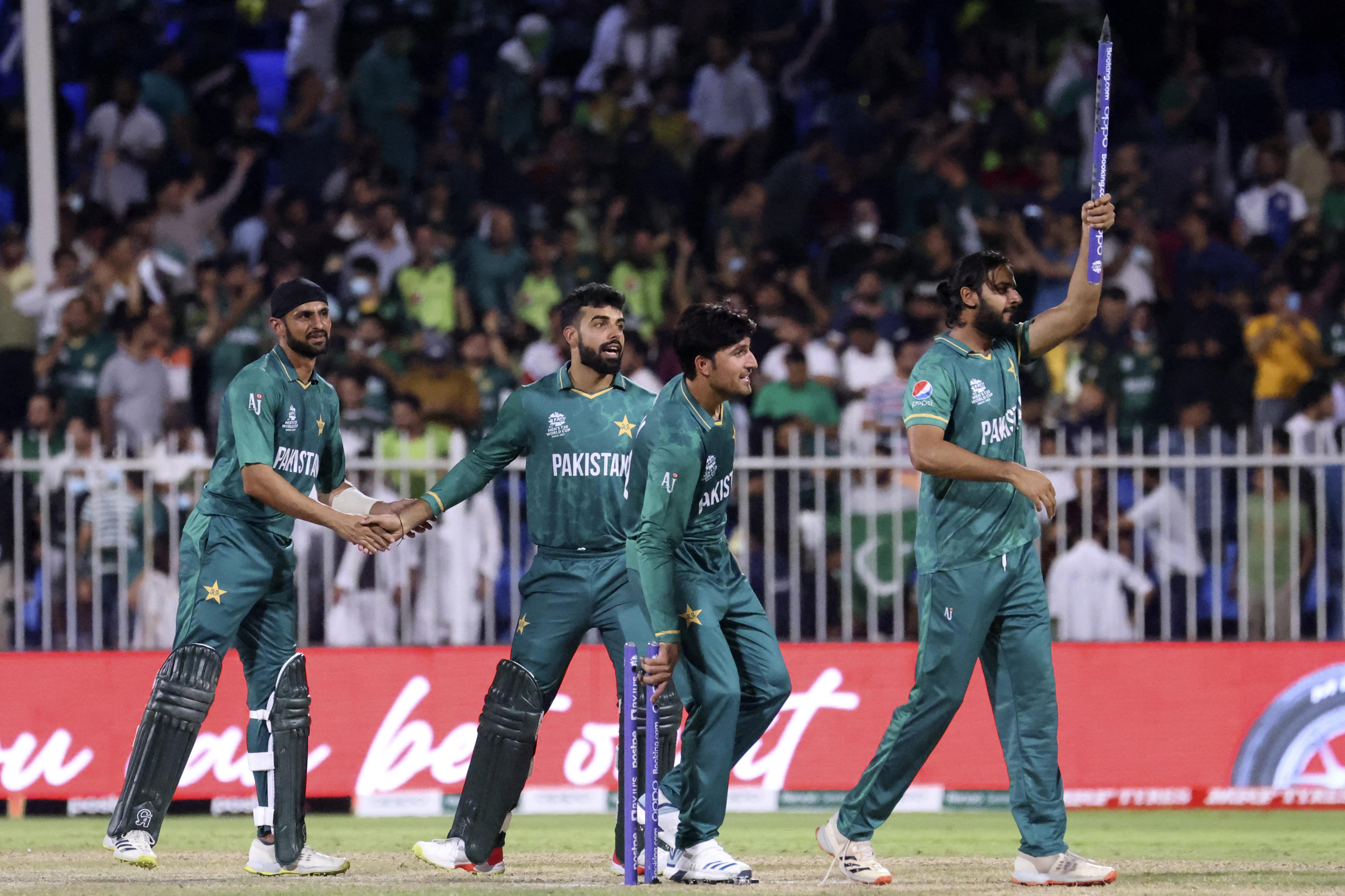 Pakistan's players celebrate at the end of the ICC men’s Twenty20 World Cup cricket match between Pakistan and New Zealand at the Sharjah Cricket Stadium in Sharjah on October 26, 2021. (AFP)