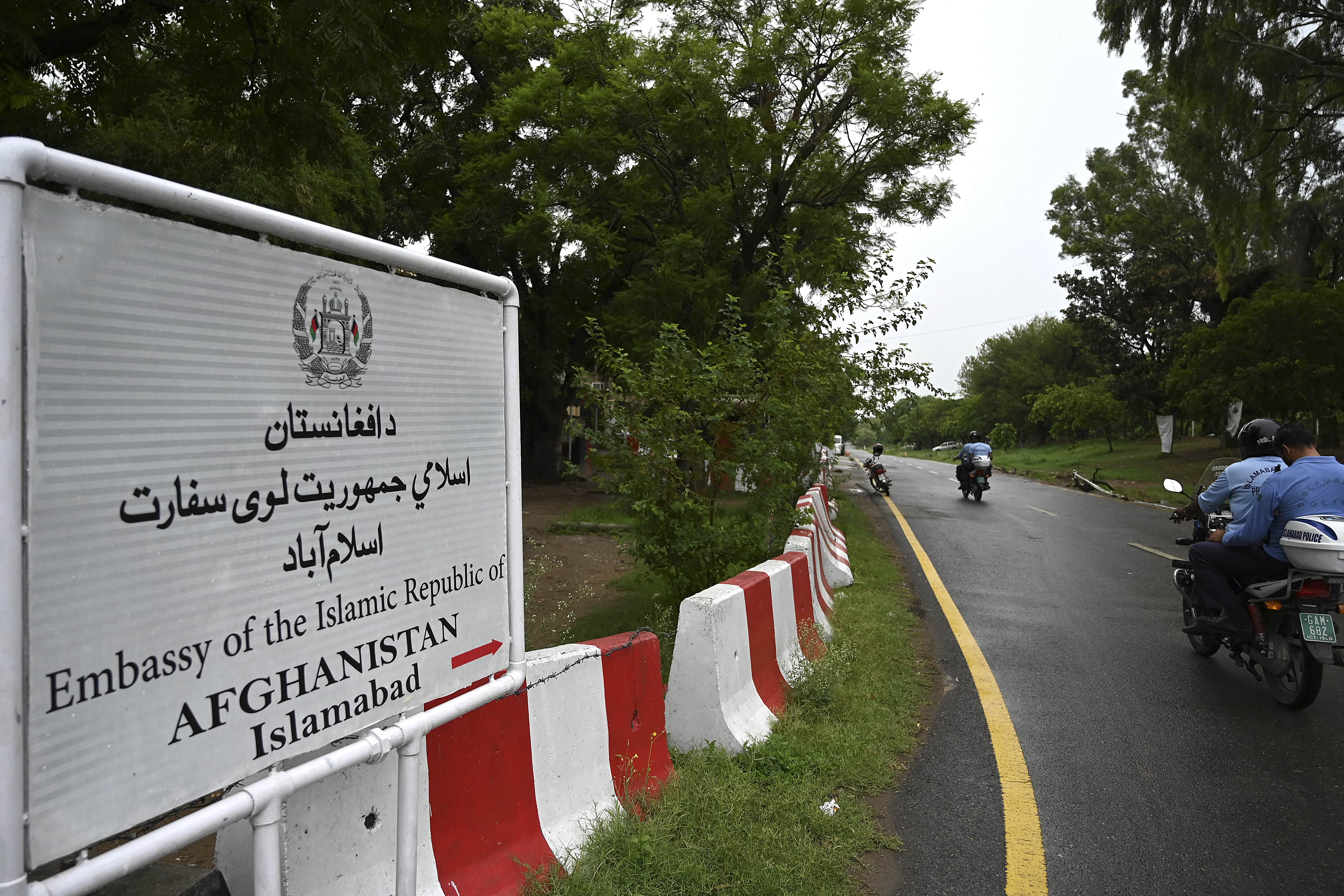 Policemen ride past the Afghan Embassy in Islamabad on July 19, 2021. (AFP)