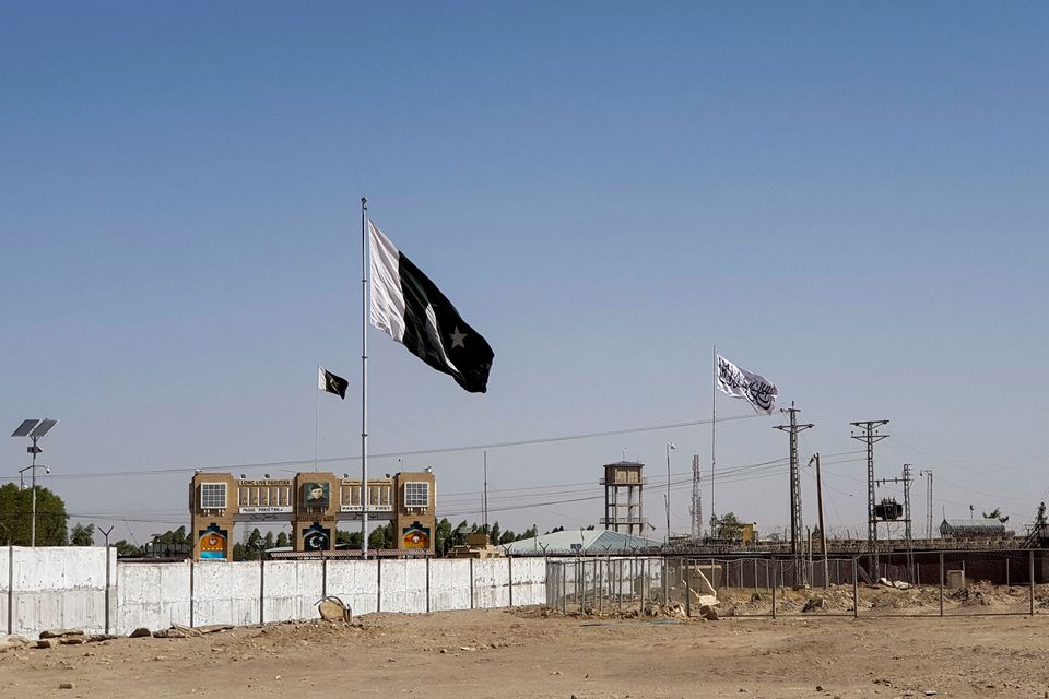 General view of the Pakistan's flag and the Taliban's flag in the background as seen from the Friendship Gate crossing point in the Pakistan-Afghanistan border town of Chaman, Pakistan August 12, 2021. (REUTERS)