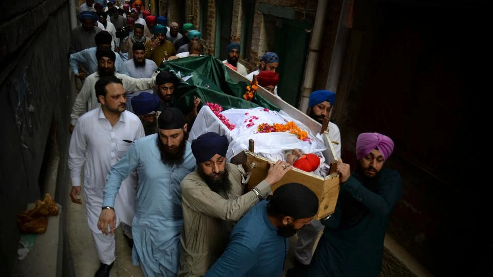 People carry the body of Charanjeet Singh who was a well-known member of the country's minority Sikh community, during his funeral, in Peshawar, Pakistan, Wednesday, May 30, 2018. (Photo courtesy: TRTWorld)