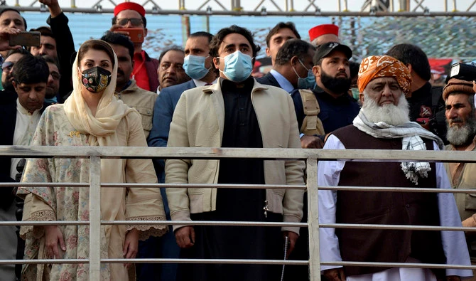Maulana Fazal-ur-Rehman, right in front row, Bilawal Bhutto Zardari, center, Maryam Nawaz Sharif, left, leaders of the Pakistan Democratic Movement, an alliance of opposition parties, attend an anti-government rally in Peshawar on Nov. 22, 2020. (AFP/ File)