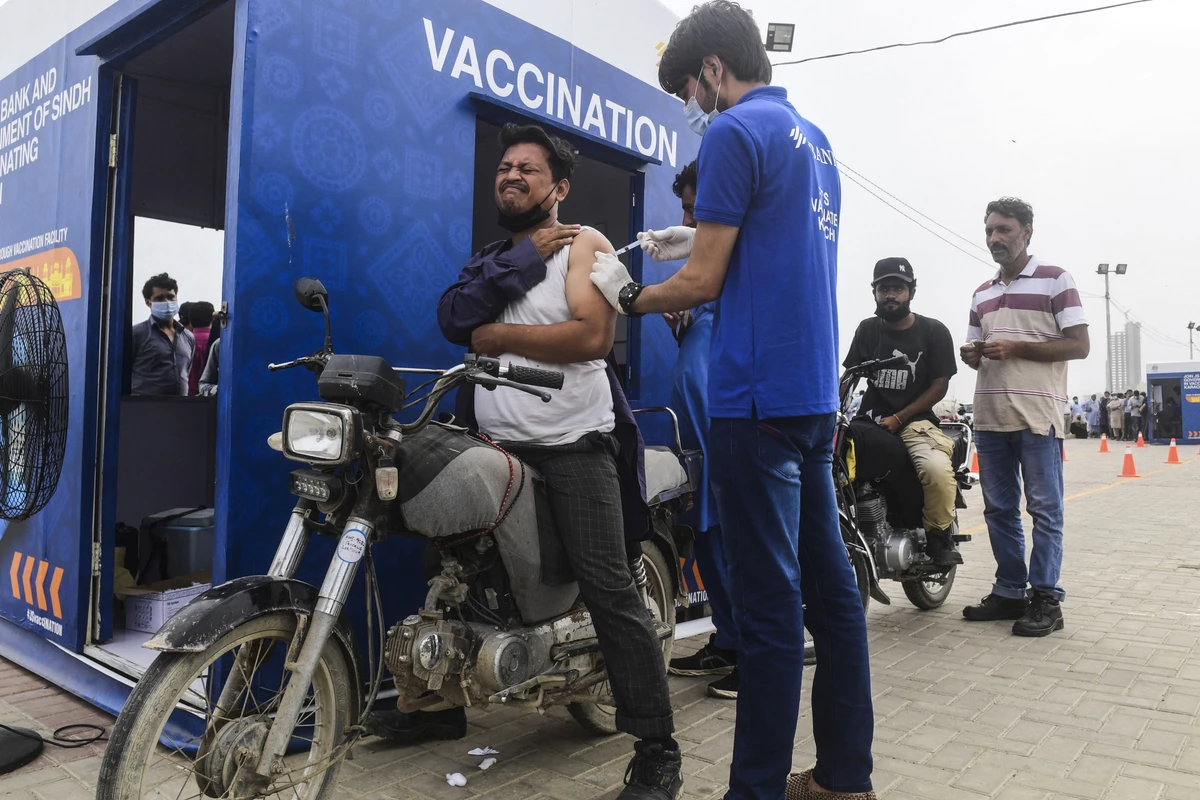 A man receives a dose of the Sinopharm vaccine against the Covid-19 coronavirus, during a drive-through vaccination in Karachi on July 26, 2021. (AFP)