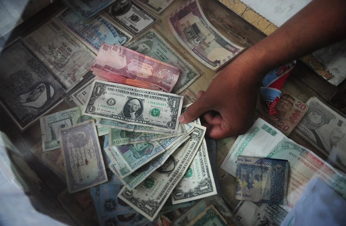 A Pakistani money exchange dealer displays foreign currency notes at his roadside stall in Karachi on August 24, 2012. (AFP/ File)