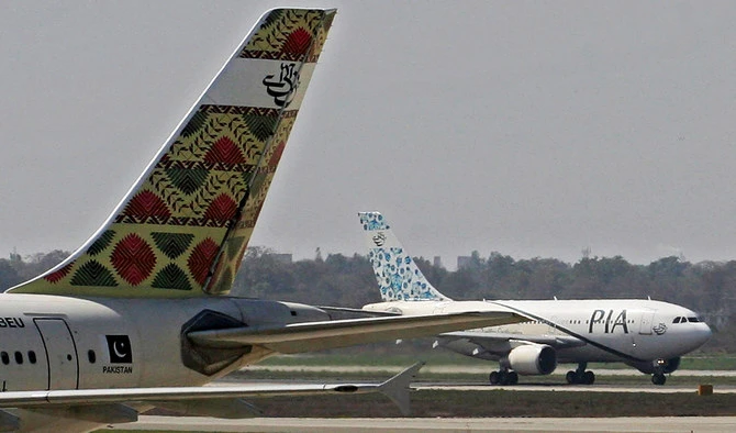 Pakistani International Airlines (PIA) aeroplanes taxi on a runway at the Allama Iqbal International Airport in Lahore on March 6, 2007. (AFP/File)