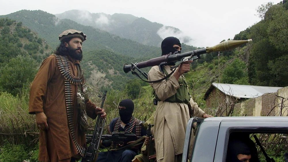 In this Aug. 5, 2012 file photo, Pakistani Taliban patrol in then their stronghold of Shawal in Pakistani tribal region of South Waziristan. The Taliban win in Afghanistan is giving a boost to militants in neighboring Pakistan. (AP/ File Photo)