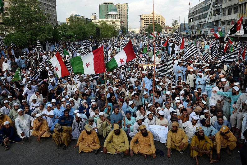 Activists from Pakistan Democratic Movement (PDM) gather to participate in an anti-government demonstration against inflation, unemployment and and other economic issues, in Karachi, Pakistan on October 22, 2021. (AFP)
