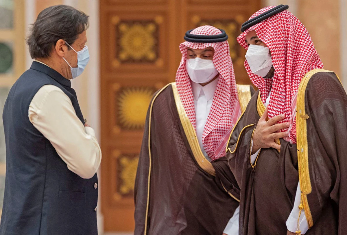 A handout picture provided by the Saudi Royal Palace on October 25, 2021 shows Saudi Crown Prince Mohammed bin Salman (R) welcoming Pakistani Prime Minister Imran Khan (L) in Saudi capital Riyadh. (AFP)