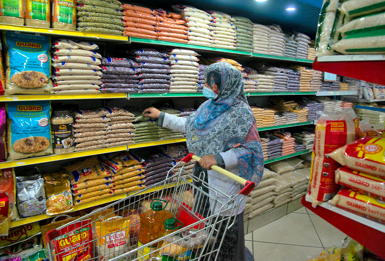 A woman buys grocery items at a store in Peshawar, Pakistan, on April 5, 2021. (AFP/File)
