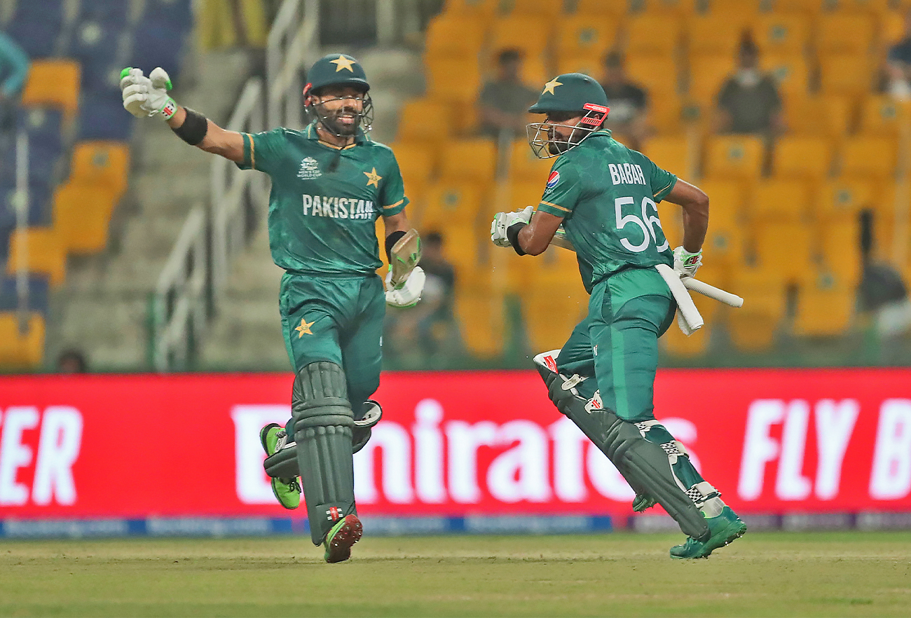 Pakistan's captain Babar Azam, right, and Mohammad Rizwan run between wickets during the Cricket Twenty20 World Cup match between Pakistan and Namibia in Abu Dhabi, UAE, on November 2, 2021. (AP)