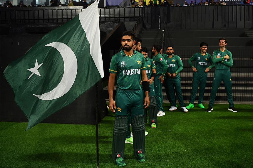 Pakistan's captain Babar Azam (L) stands near Pakistani flag after wining T20 World Cup match against Namibia at the Sheikh Zayed Cricket Stadium in Abu Dhabi on November 2, 2021. (Babar Azam Twitter)
