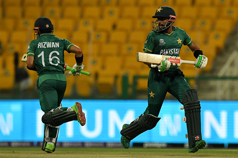 Pakistan's Mohammad Rizwan (L) with Babar Azam run between the wickets during the ICC men’s Twenty20 World Cup cricket match between Namibia and Pakistan at the Sheikh Zayed Cricket Stadium in Abu Dhabi on November 2, 2021. (AFP)