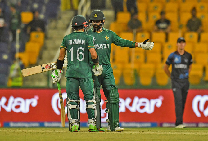 Pakistan's Mohammad Hafeez (R) greets teammate Mohammad Rizwan after he hits a boundary during the ICC men’s Twenty20 World Cup cricket match between Namibia and Pakistan in Abu Dhabi, UAE, on November 2, 2021. (AFP)