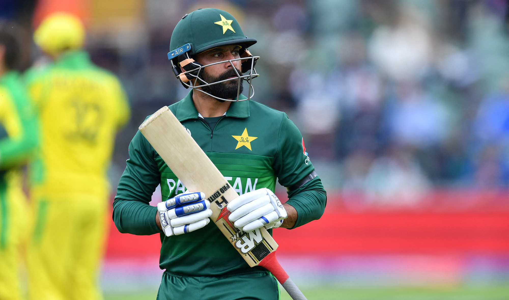 Pakistan's Mohammad Hafeez walks back to the pavilion after his dismissal during the 2019 Cricket World Cup group stage match between Australia and Pakistan at The County Ground in Taunton, southwest England, on June 12, 2019. (AFP/File)