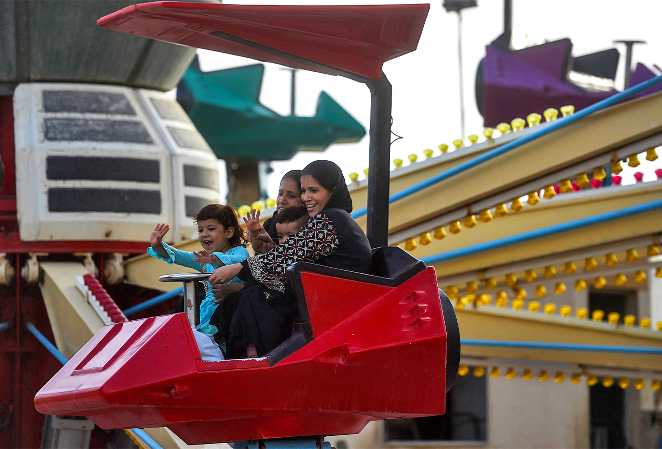 People enjoy a funfair ride in Karachi, Pakistan, on June 15, 2021, after the government eased restrictions to curb the spread of coronavirus. (AFP/File)