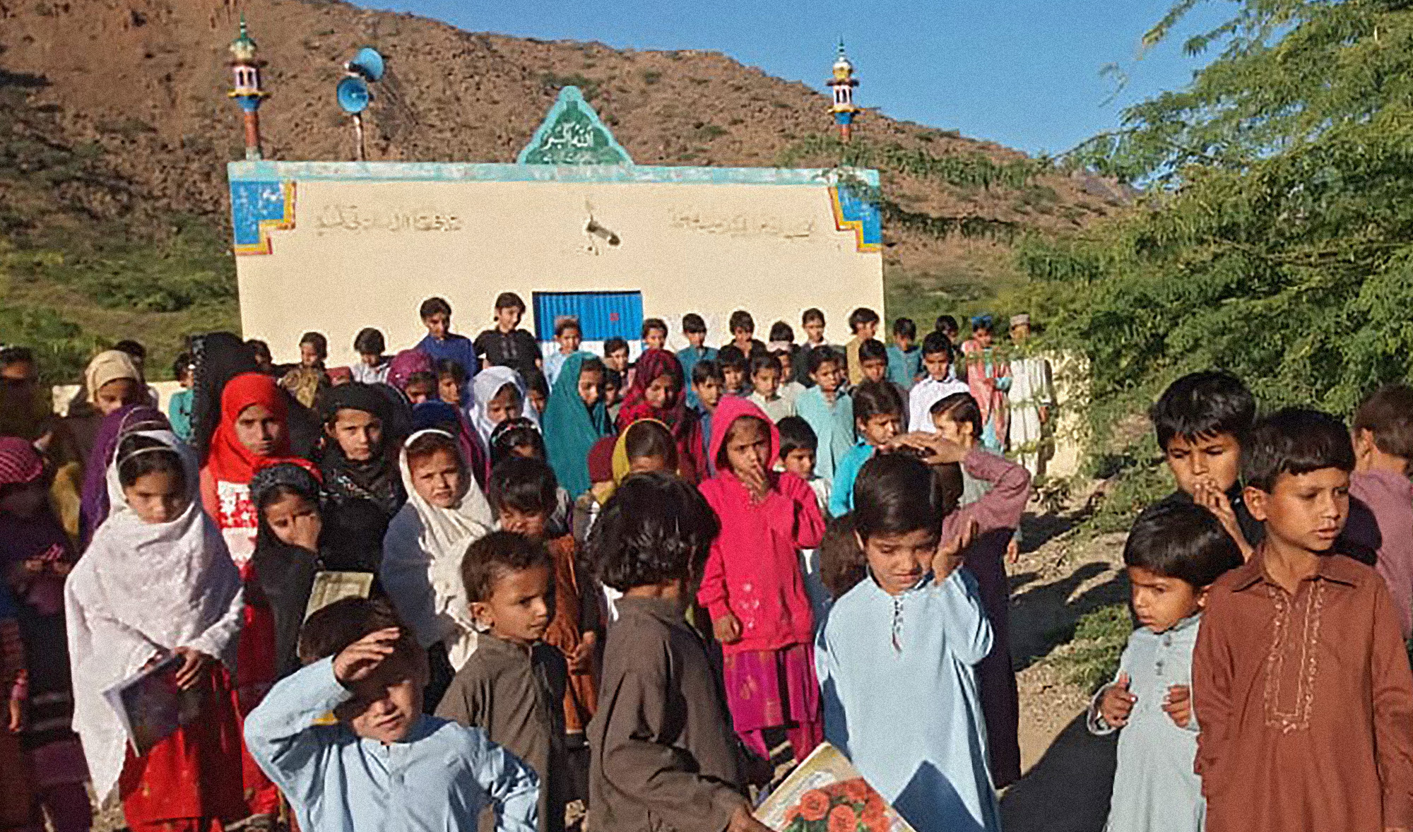 In this undated photo, children gather outside a mosque turned into a makeshift school in South Waziristan tribal district, Pakistan. (Photo credit: Haji Muhammad)