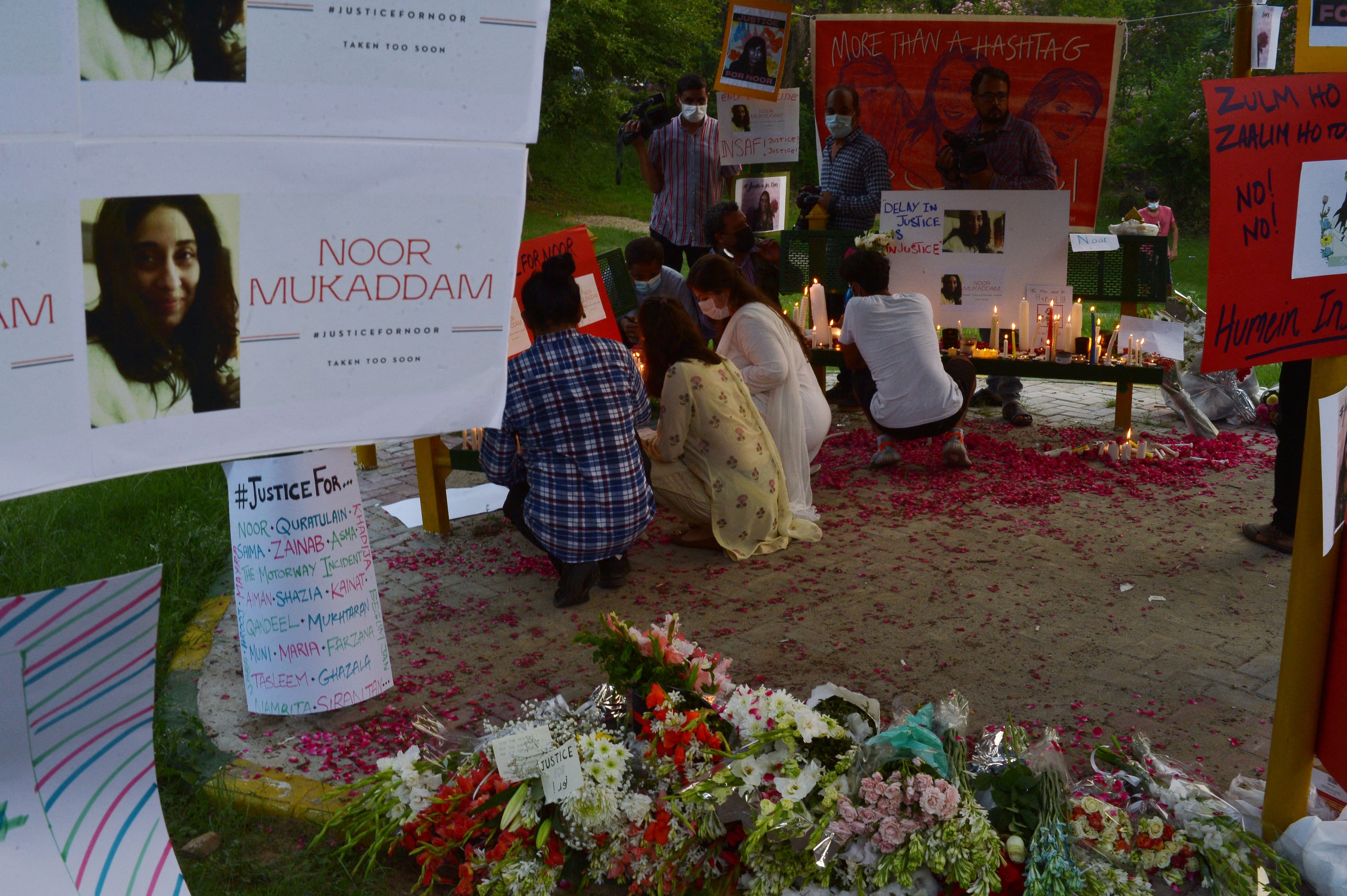Women rights activists light candles at a park in Islamabad on July 25, 2021, against the brutal killing of Noor Mukadam, the daughter of former Pakistan envoy to South Korea, in the federal capital earlier this week. (AFP)