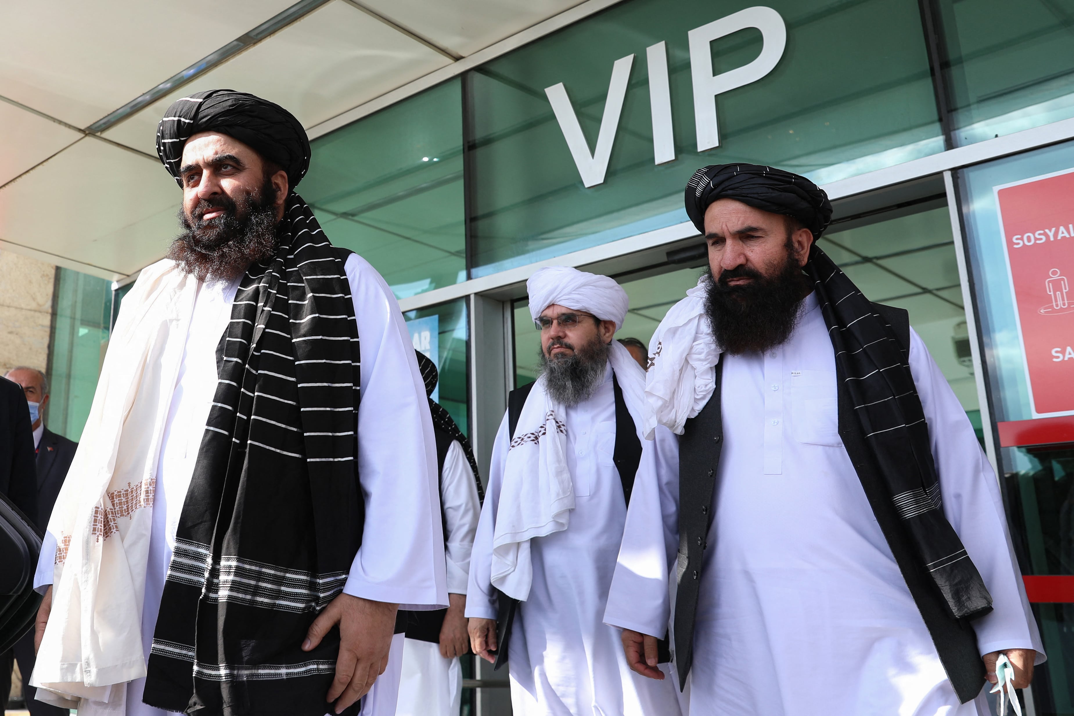 Afghanistan's interim Foreign Minister Amir Khan Muttaqi (L) and members of the Taliban delegation Shahabuddin Delawar (C) and Khairullah Khairkhwa (R) arrive at Ankara Esenboga Airport on October 14, 2021. (AFP)