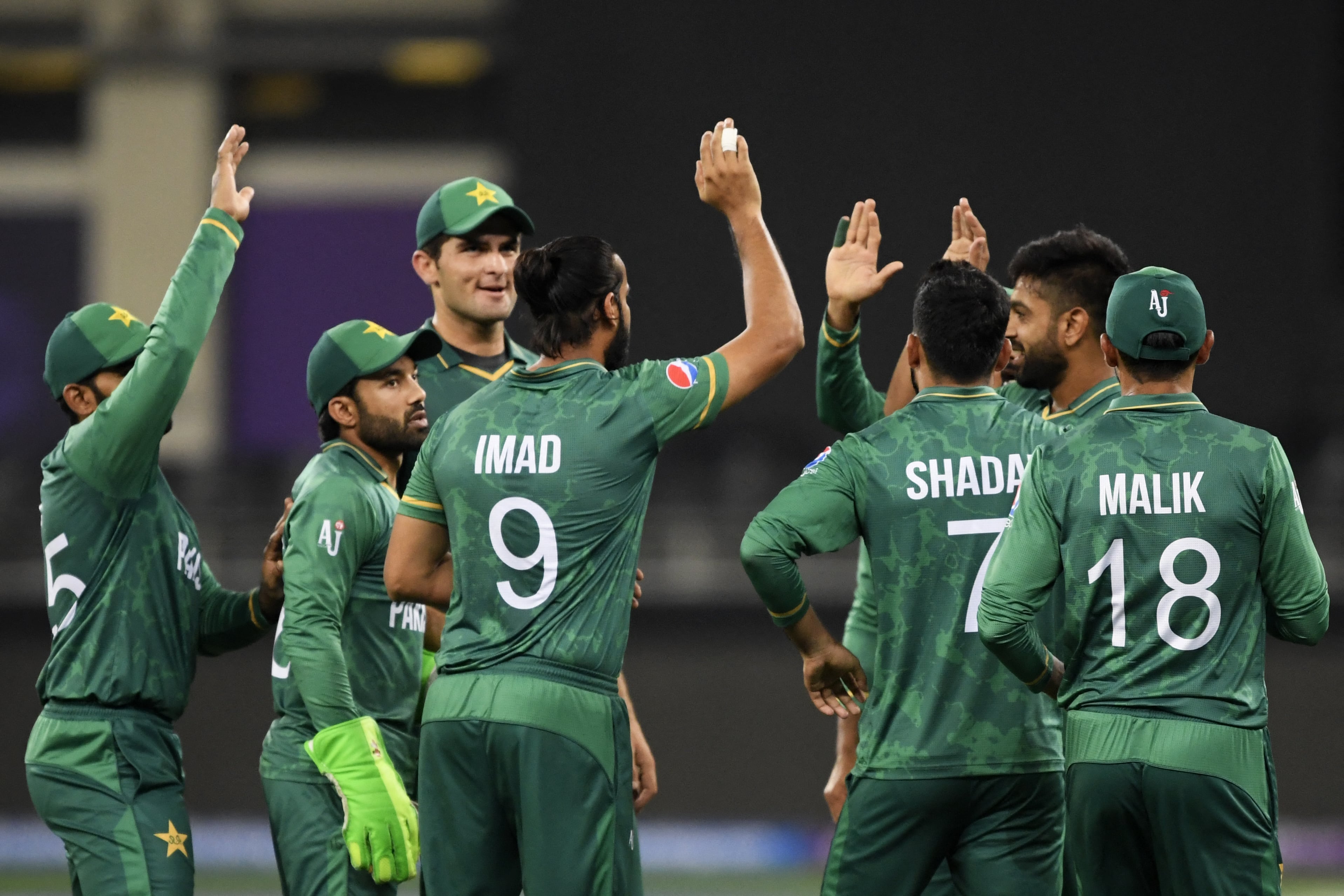 Pakistan's players celebrate after the dismissal of Afghanistan's Asghar Afghan (not pictured) during the ICC men’s Twenty20 World Cup cricket match between Afghanistan and Pakistan at the Dubai International Cricket Stadium in Dubai on October 29, 2021. (AFP)