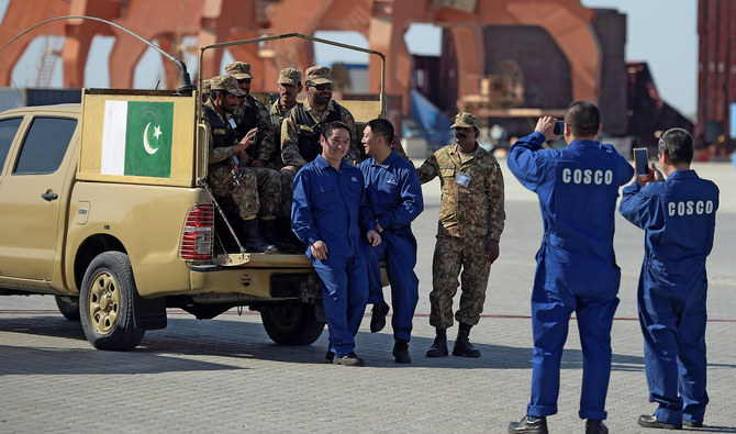 In this file photo, Chinese workers pose for a picture with Pakistani soldiers at a ceremony to open a pilot trade project in Gwadar port on Nov. 13, 2016. (AFP / File)