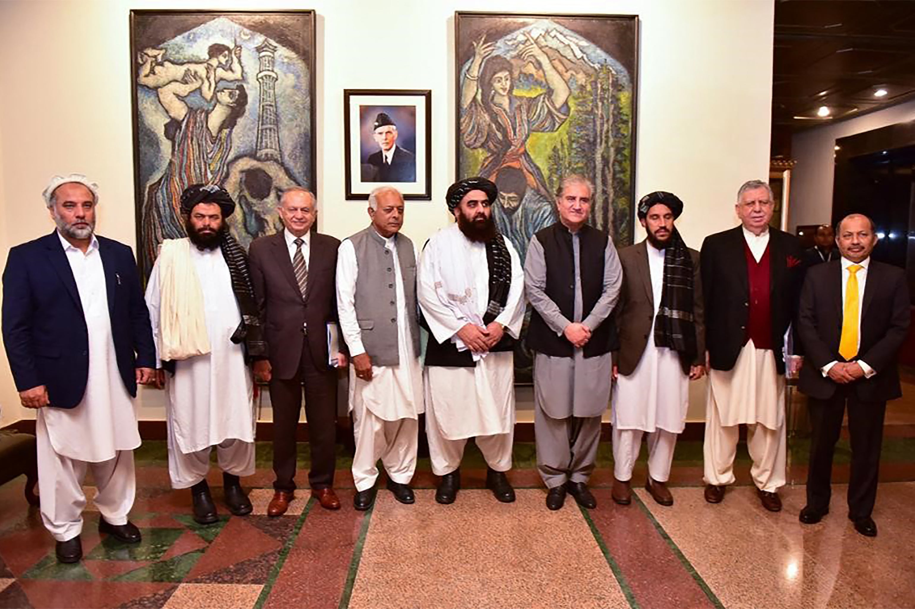 This handout photograph taken and released by Pakistan's Ministry of Foreign Affairs on November 11, 2021, shows Afghanistan's acting Foreign Minister Amir Khan Muttaqi (C), Pakistan's Foreign Minister Shah Mahmood Qureshi (4R), Pakistan Minister for Aviation Ghulam Sarwar Khan (4L), Pakistan's Prime Minister commerce adviser Abdul Razak Dawood (3L) pose for picture along with other delegation members at Pakistan's Foreign Ministry, in Islamabad, Pakistan. (AFP)