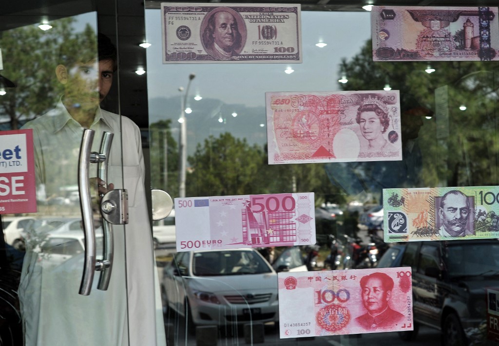 A Pakistani man exits a currency exchange shop in Islamabad on October 14, 2010. (AFP/File)