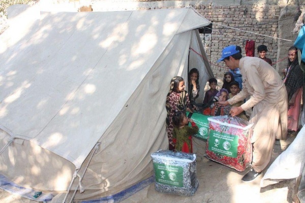 A worker of King Salman Humanitarian Aid and Relief Center (KSRelief) distributes winter aid to kids in an earthquake-hit district in Pakistan's southwestern Balochistan province on Nov 14, 2021. (SPA)