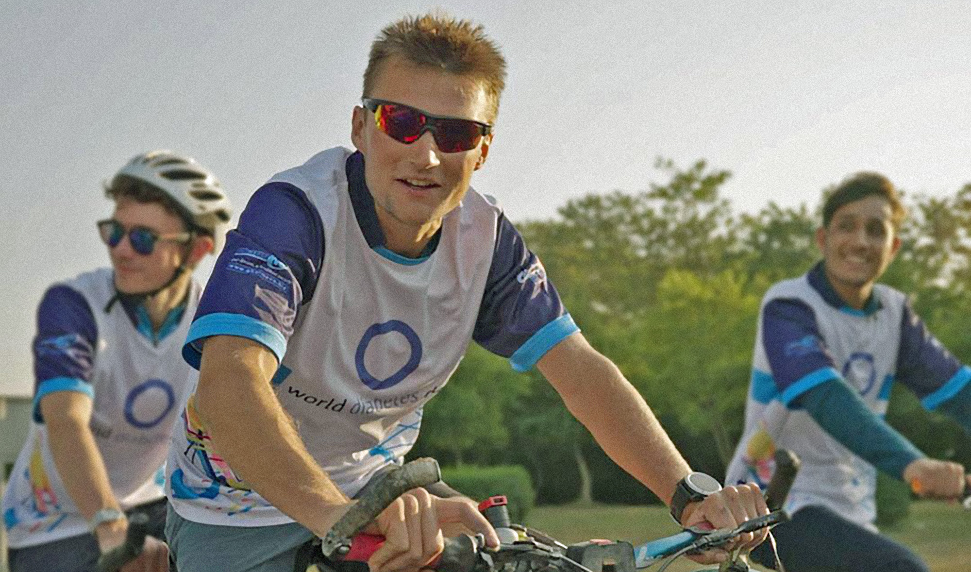 Luke Grenfell-Shaw, center, arrives in Pakistan's capital Islamabad on a tandem on November 16, 2021. (Photo courtesy: @bristol2beijing/Instagram)